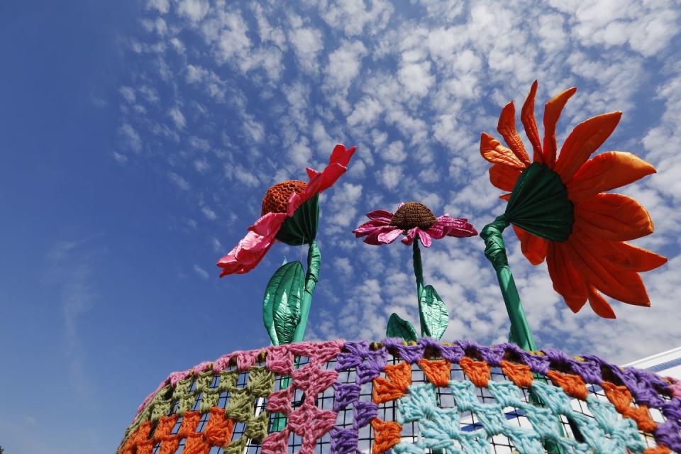 fabric flowers in a crocheted flower pot create an entrance to the floral marquee at rhs hampton court palace flower show 2018