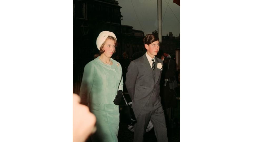 Teenager Princess Anne in a blue skirt suit with her older brother Prince Charles