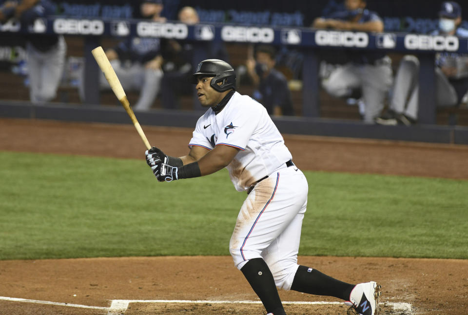 Miami Marlins' Jesus Aguliar hits a single in the first inning during a baseball game against the Tampa Bay Rays, Thursday, April 1, 2021, in Miami. (AP Photo/Gaston De Cardenas)