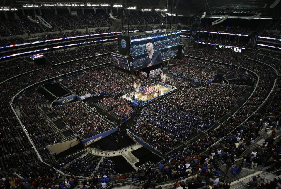 Chris Daughrty performs the U.S. national anthem before an NCAA Final Four tournament college basketball semifinal game between Connecticut and Florida Saturday, April 5, 2014, in Arlington, Texas. (AP Photo/David J. Phillip)