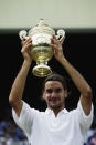 <p>Roger Federer of Switzerland holds the trophy after his victory over Mark Philippoussis of Australia in the Men’s Singles Final in July 2003. </p>