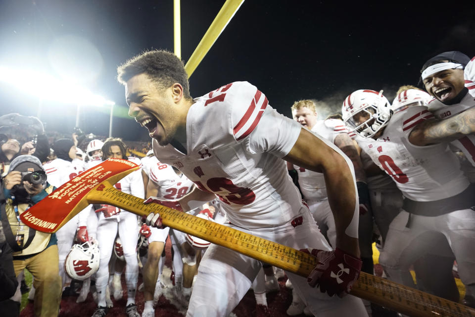 Wisconsin wide receiver Chimere Dike (13) celebrates after the 28-14 win against Minnesota of an NCAA college football game Saturday, Nov. 25, 2023, in Minneapolis. (AP Photo/Abbie Parr)