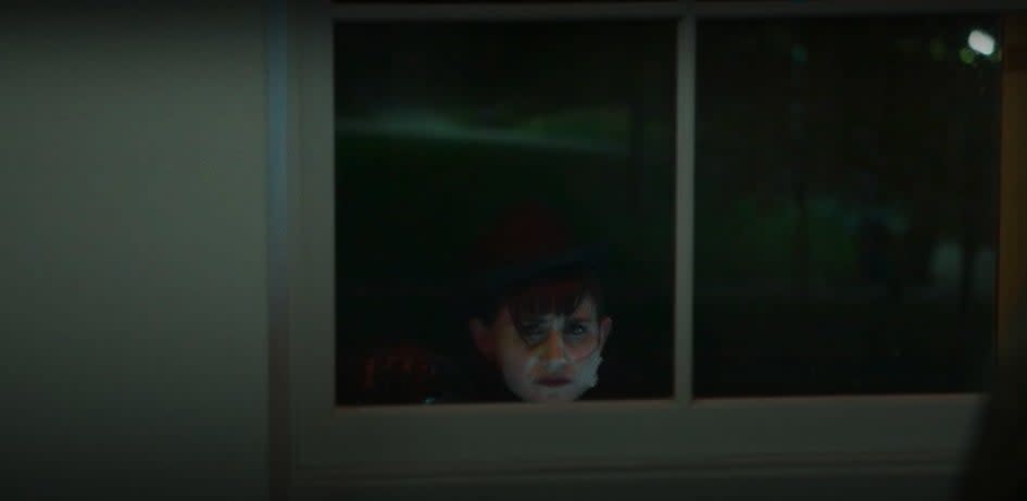 Nadja staring sadly through a window in "What We Do in the Shadows"