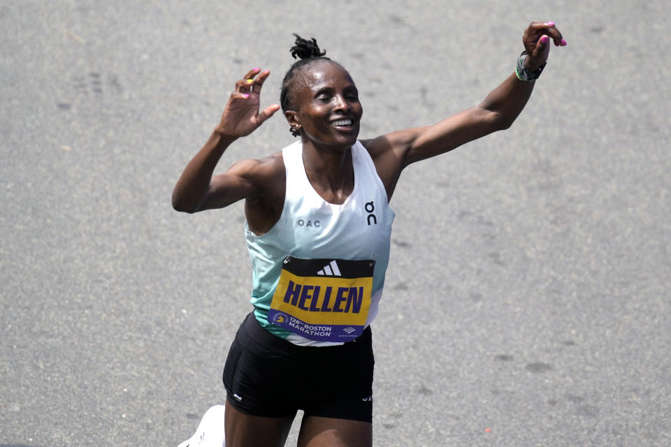 Hellen Obiri, of Kenya, raises her arms after winning the women's division at the Boston Marathon, Monday, April 15, 2024, in Boston. (AP Photo/Charles Krupa)