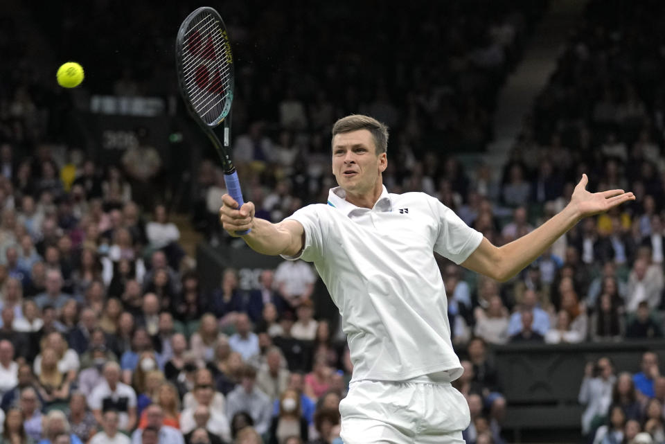 Poland's Hubert Huekacz plays a return during the men's singles fourth round match against Russia's Daniil Medvedev on day eight of the Wimbledon Tennis Championships in London, Tuesday, July 6, 2021. (AP Photo/Kirsty Wigglesworth)