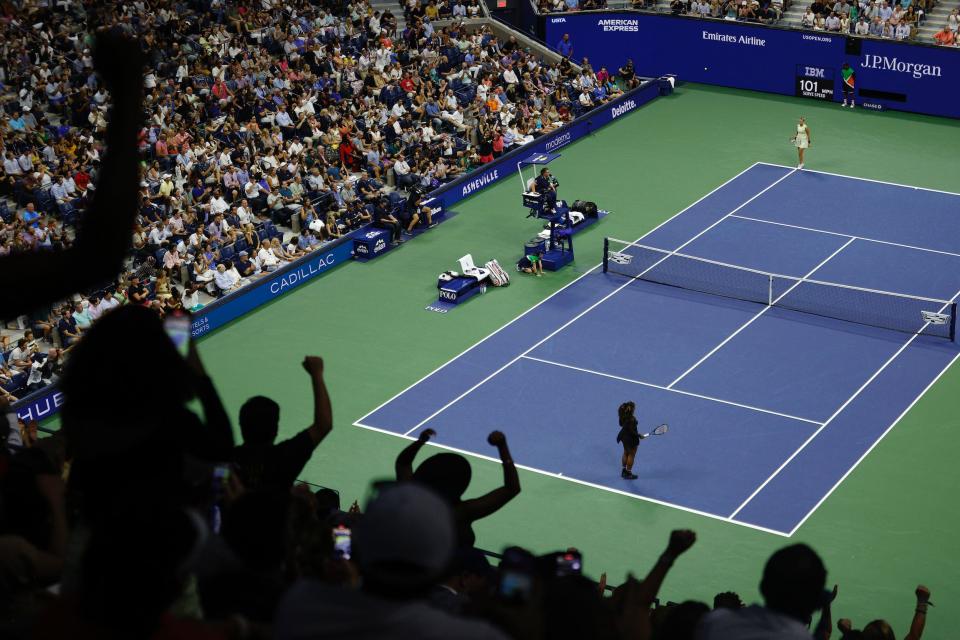 Serena Williams stands just inside the baseline after serving an ace to secure the first set.