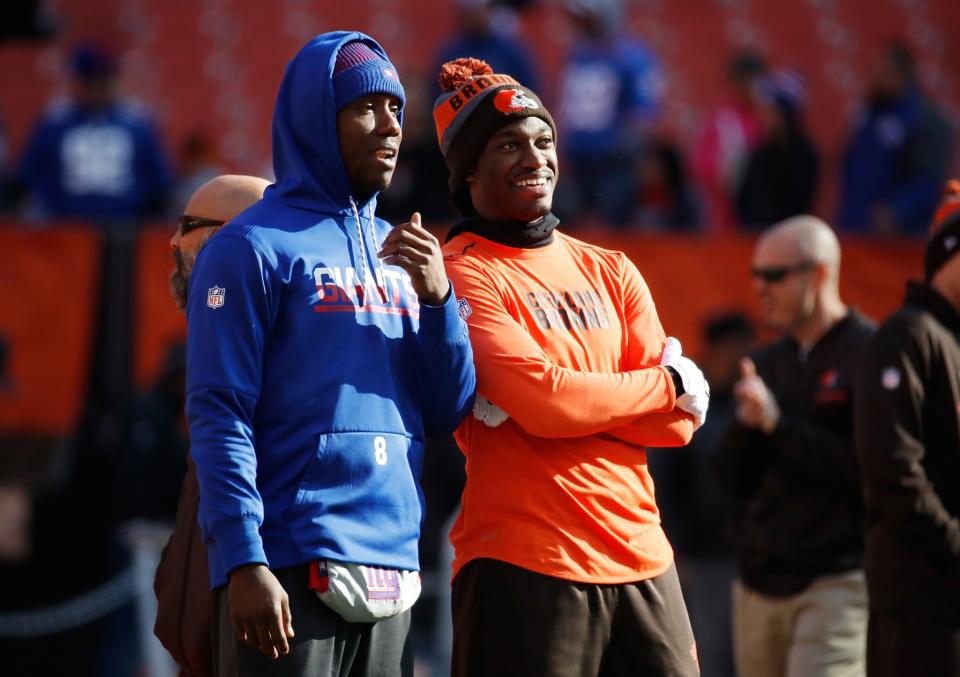 Cleveland Browns QB Robert Griffin III, right, reportedly had money stolen from his car during Sunday's game. (Getty Images)