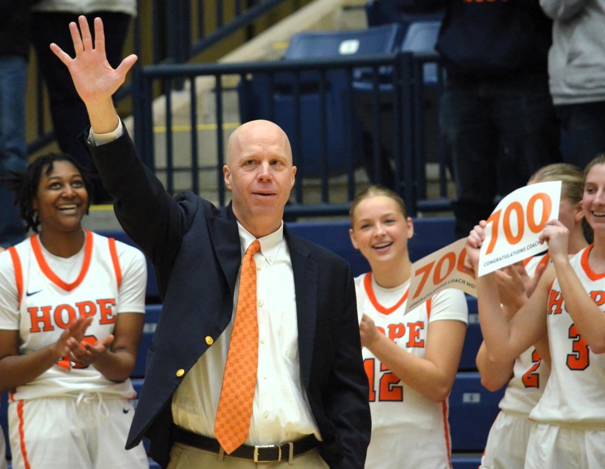 Hope College women's basketball coach Brian Morehouse celebrates with his team after winning the 700th game of his career, a double-overtime win over Alma on Saturday, Jan. 13, 2024, at DeVos Fieldhouse.
