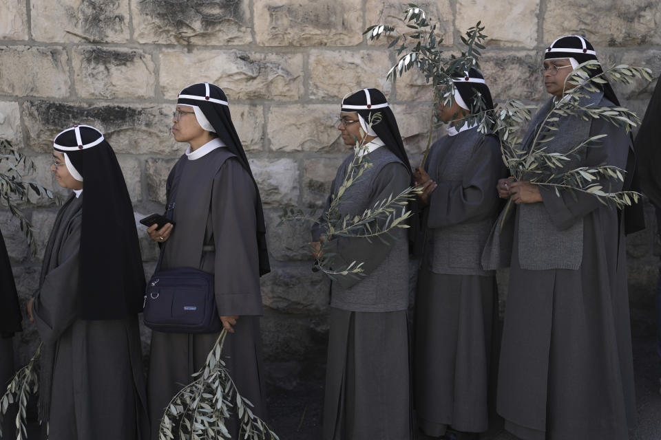 Nuns take part in the Palm Sunday procession on the Mount of Olives in east Jerusalem, Sunday, April 2, 2023. The procession observes Jesus' entrance into Jerusalem in the time leading up to his crucifixion, which Christians mark on Good Friday. (AP Photo/Mahmoud Illean)