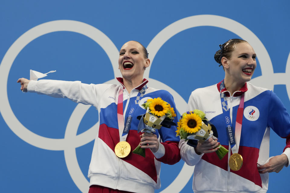 First placed Svetlana Kolesnichenko and Svetlana Romashina of Russian Olympic Committee celebrate during the medal ceremony of the duet free routine final at the the 2020 Summer Olympics, Wednesday, Aug. 4, 2021, in Tokyo, Japan. (AP Photo/Alessandra Tarantino)