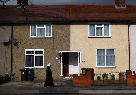 A woman walks along a residential street in Dagenham, east London, Britain, March 18, 2019. Picture taken March 18, 2019. REUTERS/Hannah McKay