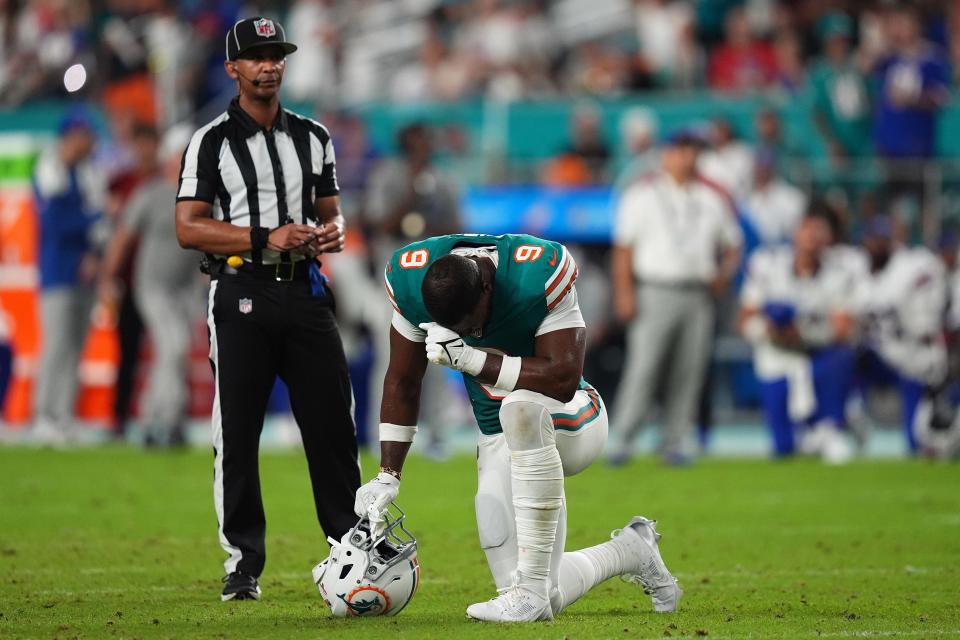 Sep 12, 2024; Miami Gardens, Florida, USA; Miami Dolphins tight end Jonnu Smith (9) reacts on the field while training staff members attend to quarterback Tua Tagovailoa (1, not pictured) after an apparent injury during the second half against the Buffalo Bills at Hard Rock Stadium. Mandatory Credit: Jasen Vinlove-Imagn Images