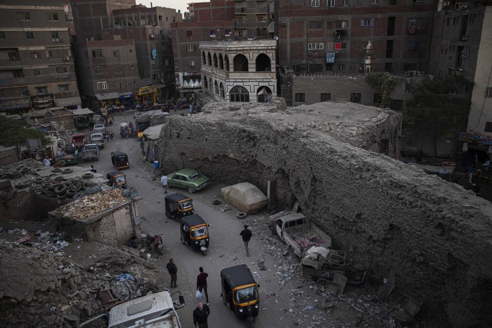 In this Nov. 24, 2019 photo, tuk-tuk drivers make their way on a street in a slum area of Cairo, Egypt. Motorized rickshaws known as tuk-tuks have ruled the streets of Cairo’s slums for the past two decades hauling millions of Egyptians home every day. Now the government is taking its most ambitious stand yet against the polluting three-wheeled vehicles: to modernize the neglected transport system, it plans to replace tuk-tuks with clean-running minivans. (AP Photo/Nariman El-Mofty)