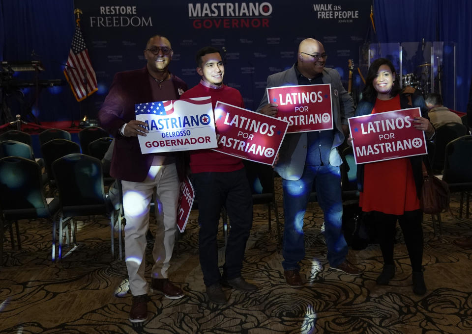 Supports of Pennsylvania Republican gubernatorial candidate Doug Mastriano pose for photographs during his election night campaign gathering at the Penn Harris Hotel in Camp Hill, Pa., Tuesday, Nov. 8, 2022. (AP Photo/Carolyn Kaster)