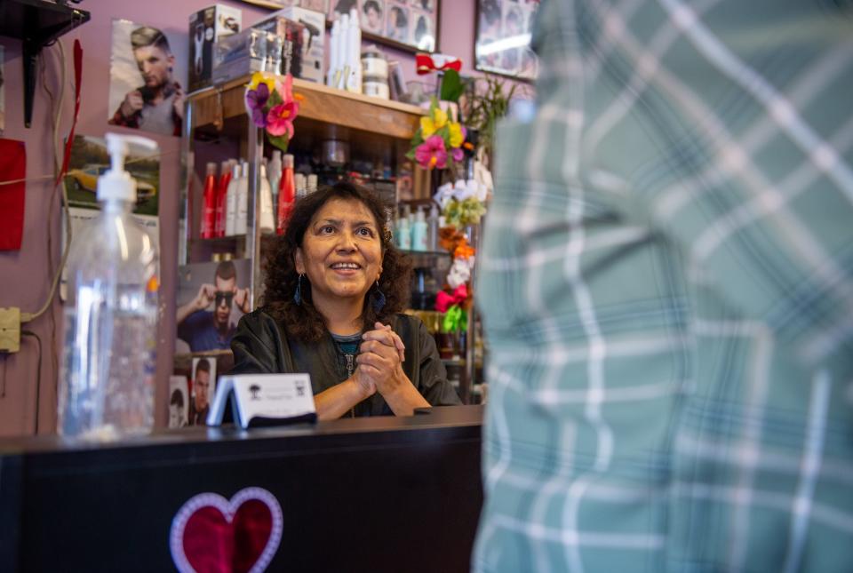 Fausta Ibarra, 59, owner of Tropical Cuts Beauty Salon in Salinas greets a costumer early morning on Feb. 07, 2020. 