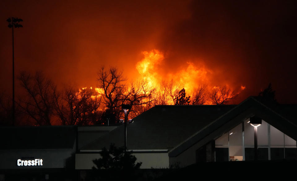 FILE — Flames explode as a wildfire burns near a small shopping center, Dec. 30, 2021, near Broomfield, Colo. Authorities say they have wrapped up their investigation into what started the most destructive wildfire in Colorado history and will announce their findings on Thursday, June 8, 2023. (AP Photo/David Zalubowski, File)