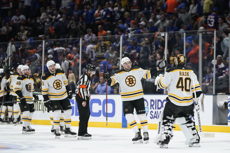 Boston Bruins goaltender Tuukka Rask (40) celebrates with Charlie McAvoy (73) and other teammates after Game 3 during an NHL hockey second-round playoff series against the New York Islanders Thursday, June 3, 2021, in Uniondale, N.Y. The Bruins won 2-1. (AP Photo/Frank Franklin II)