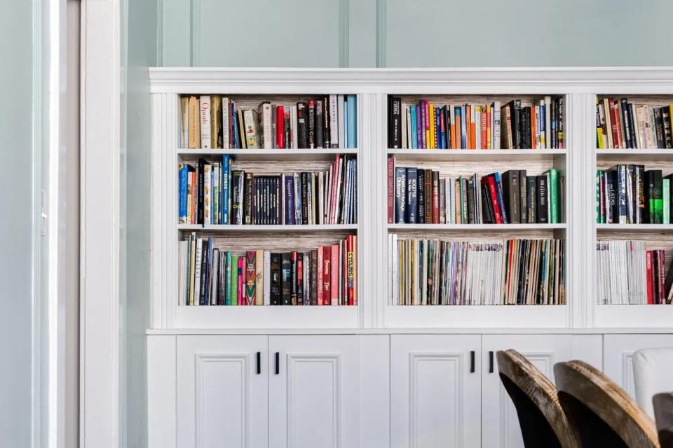 IKEA BIlly bookcase and Sektion kitchen base cabinets used together to recreate the look of expensive built-in shelving.