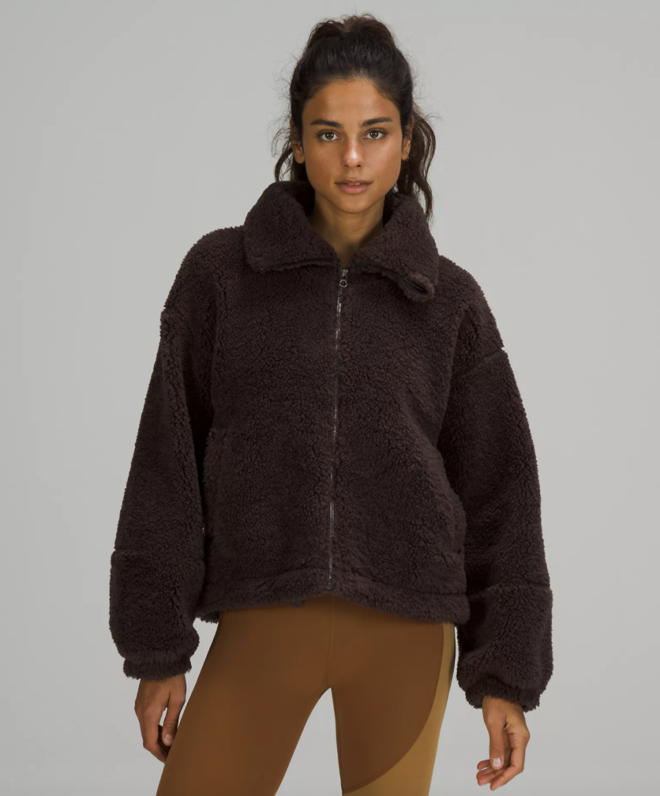 model wearing coffee brown leggings and Cinchable Fleece Zip-Up in dark brown (Photo via Lululemon)