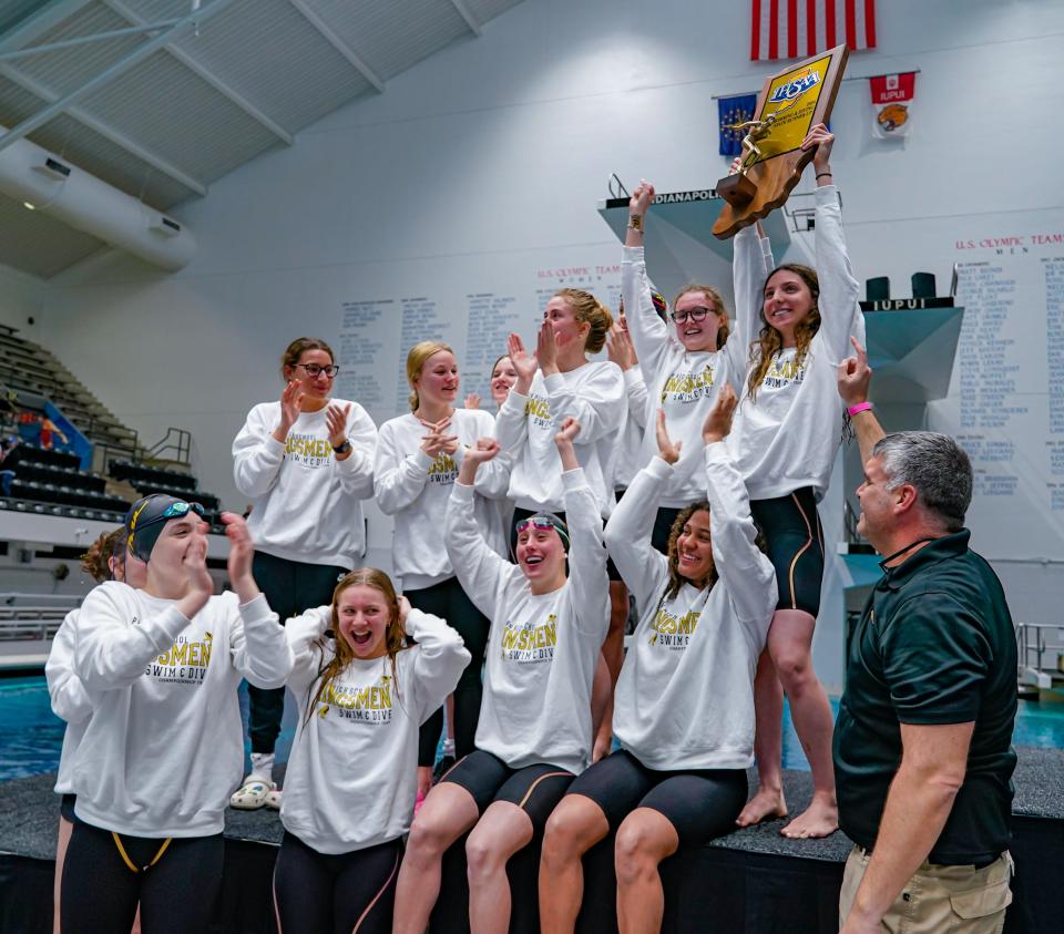 Members of the Kingman High School Girls Swimming and Diving team celebrate as State Finals Runner-Up, during the 50th Annual Girls Swimming and Diving State Finals at the IU Natatorium on Saturday, Feb. 10, 2024 in Indianapolis.