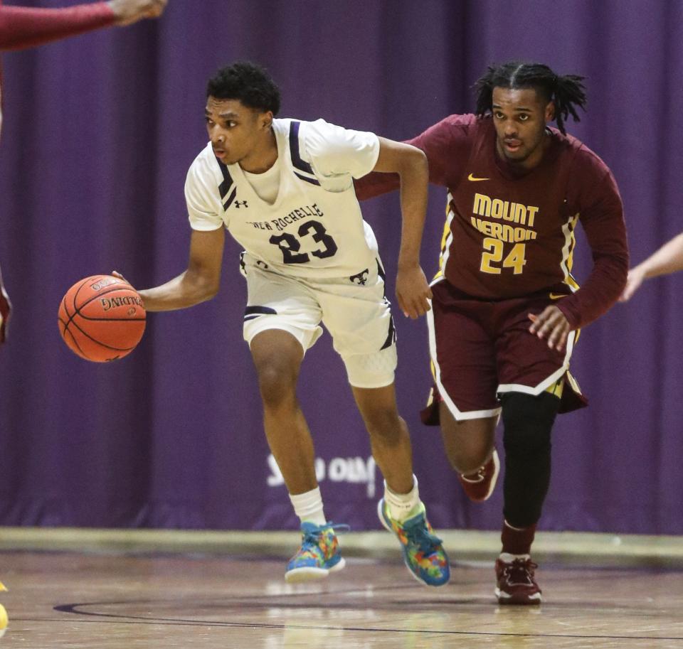 Zyon Lord of New Rochelle dribbles up court while being defended by Chris Fitzgerald of Mount Vernon during a varsity basketball game New Rochelle High School Feb. 7, 2023. Mount Vernon defeated New Rochelle 66-56.