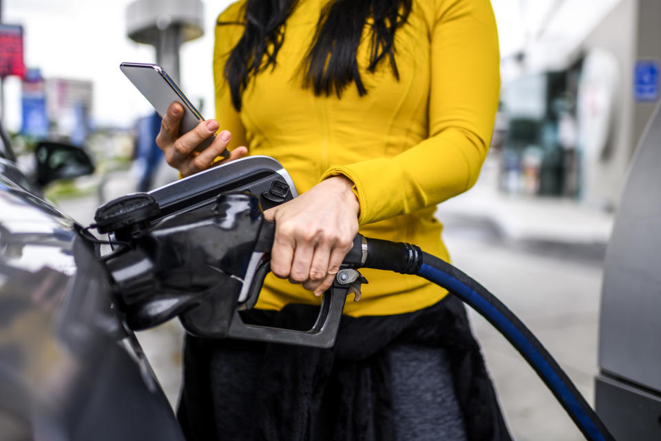 Woman pumping gas