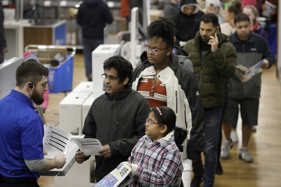 People wait in line to purchase a computer during a Black Friday sale at a Best Buy store Thursday, Nov. 28, 2019, in Overland Park, Kan. (AP Photo/Charlie Riedel)