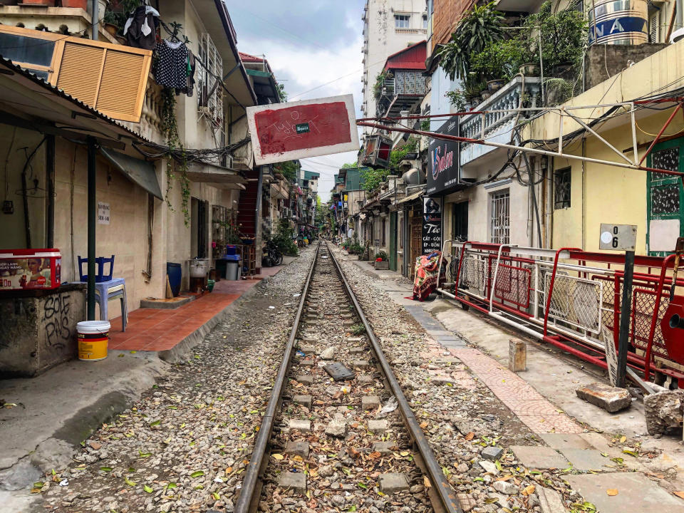 In the crowded streets of smoggy Hanoi, a train passes very, very close by people's homes. (Photo: Alexander C. Kaufman / HuffPost)