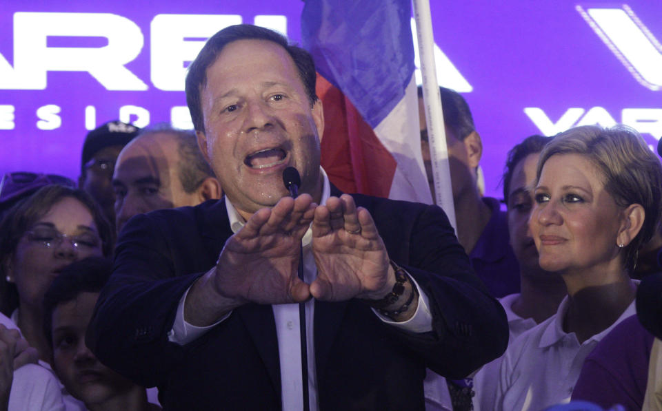 Juan Carlos Varela, Panama's president elect, delivers his acceptance speech as his wife Lorena Castillo, right, looks on in Panama City, Sunday, May 4, 2014. Varela was declared the victor of Panama's presidential election, thwarting an attempt by former ally President Ricardo Martinelli to extend his grip on power by electing a hand-picked successor. (AP Photo/Arnulfo Franco)