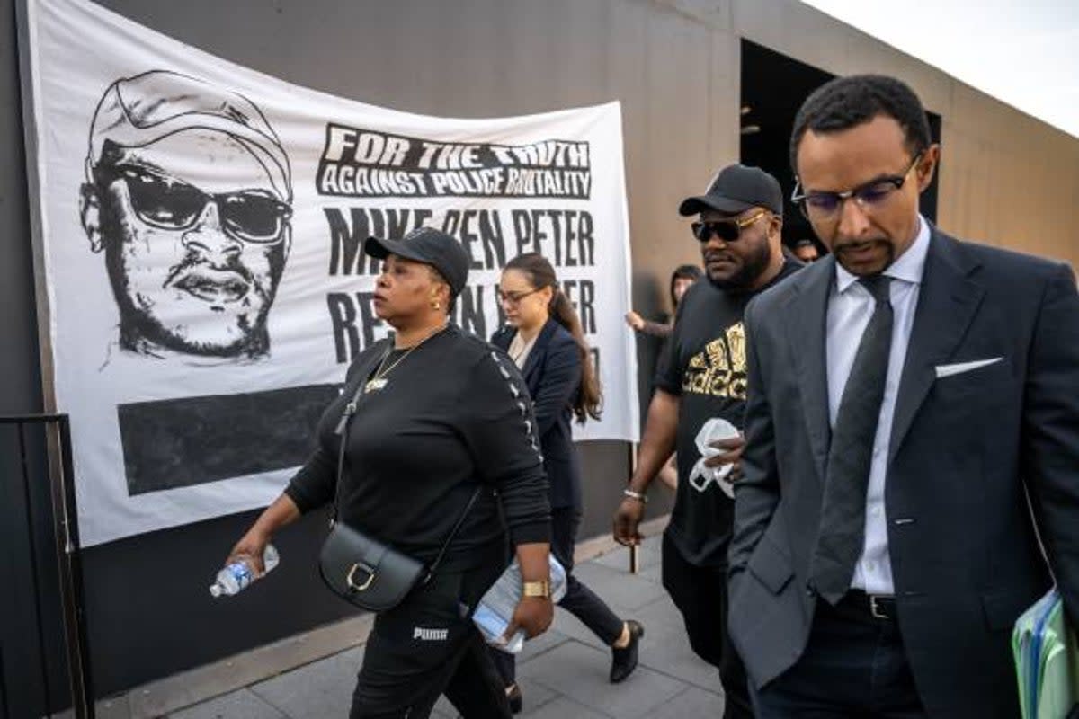 Bridget Efe (L), the wife of Mike Ben Peter, a 39-year-old Nigerian who died in Lausanne in March 2018, his brother (2R) and lawyer Simon Ntah (R) arrive at the criminal court at the opening of the trial of six policemen accused of homicide charges for his death, in Renens on 12 June 2023 (AFP via Getty Images)