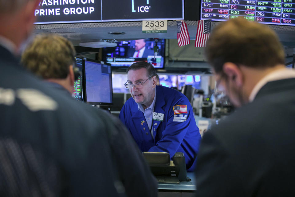 In this photo provided by the New York Stock Exchange, specialist Patrick King works with traders on the floor of the NYSE, Monday, June 14, 2021. Stocks fell on Wall Street Monday in a sluggish start to the week as investors await the latest take from the Federal Reserve on inflation. (Courtney Crow/New York Stock Exchange via AP)