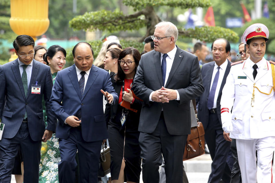 Australian Prime Minister Scott Morrison, center, talks with his Vietnamese counterpart Nguyen Xuan Phuc, second from left, while walking at the Presidential Palace in Hanoi, Vietnam, Friday, Aug. 23, 2019. Morrison is on a three-day official visit to Vietnam. (AP Photo/Duc Thanh)