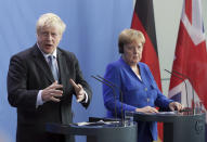 German Chancellor Angela Merkel and Britain's Prime Minister Boris Johnson address the media during a joint press conference as part of a meeting at the Chancellery in Berlin, Germany, Wednesday, Aug. 21, 2019. (AP Photo/Michael Sohn)