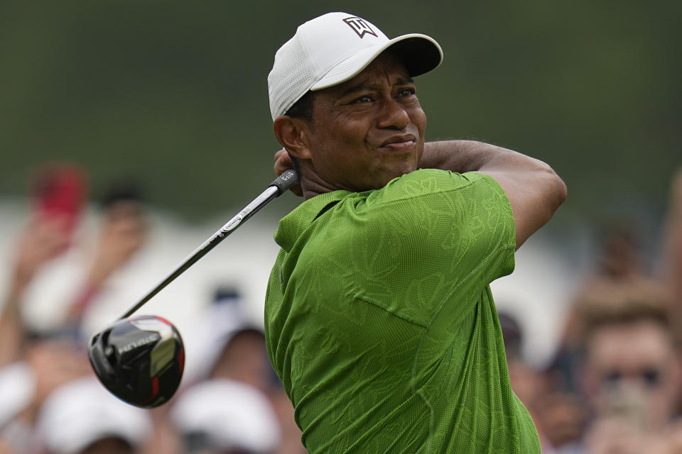 FILE - Tiger Woods watches his tee shot on the second hole during the second round of the PGA Championship golf tournament at Southern Hills Country Club, May 20, 2022, in Tulsa, Okla. Woods withdrew from his Hero World Challenge on Monday, Nov. 28, 2022, because of plantar fasciitis in his right foot. (AP Photo/Sue Ogrocki, File)