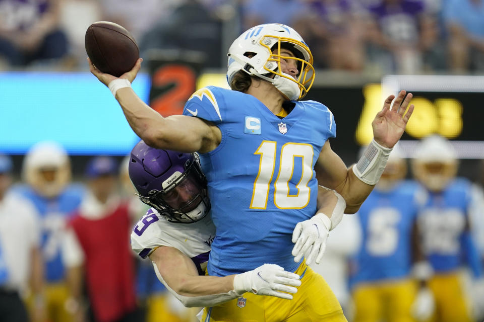 Minnesota Vikings outside linebacker Nick Vigil (59) puts pressure on Los Angeles Chargers quarterback Justin Herbert (10), who throws an incomplete pass during the second half of an NFL football game Sunday, Nov. 14, 2021, in Inglewood, Calif. (AP Photo/Marcio Jose Sanchez)