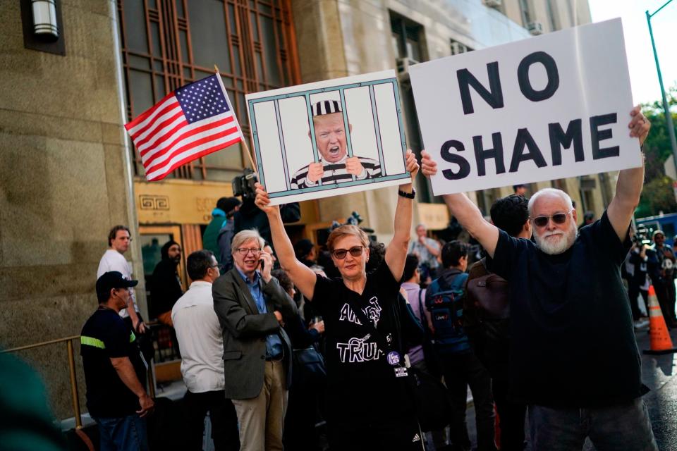 People wait for the arrival of former White House strategist Steve Bannon outside the Manhattan district attorney's office before surrendering himself to New York authorities Thursday, Sept. 8, 2022, in New York.