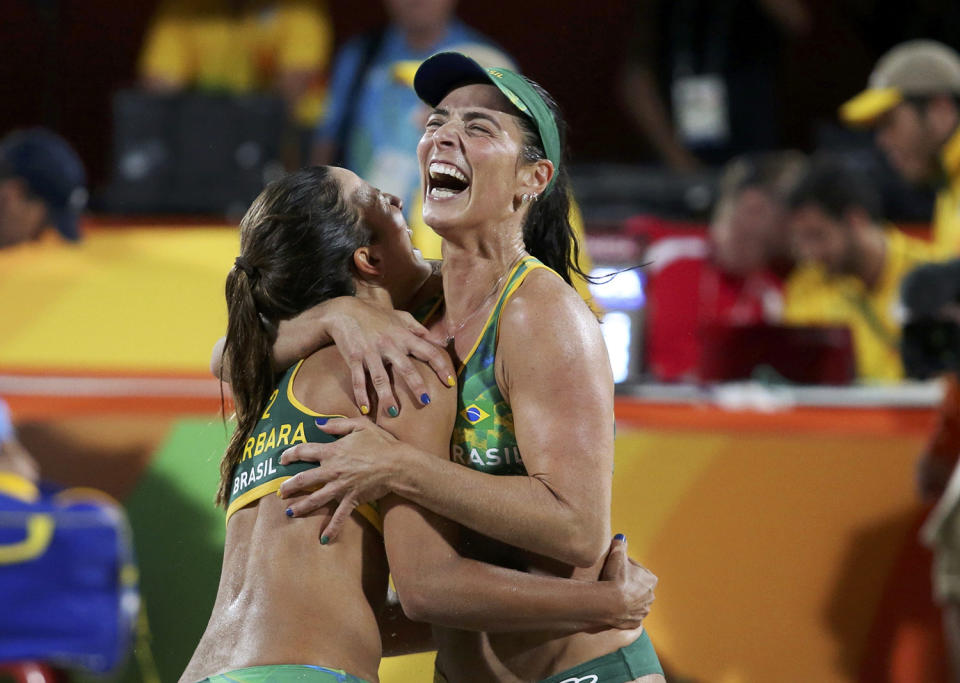 <p>Barbara Seixas Figueiredo and Agatha Bednarczuk of Brazil celebrate after winning a semifinal against the USA in women’s volleyball. (REUTERS/Adrees Latif) </p>