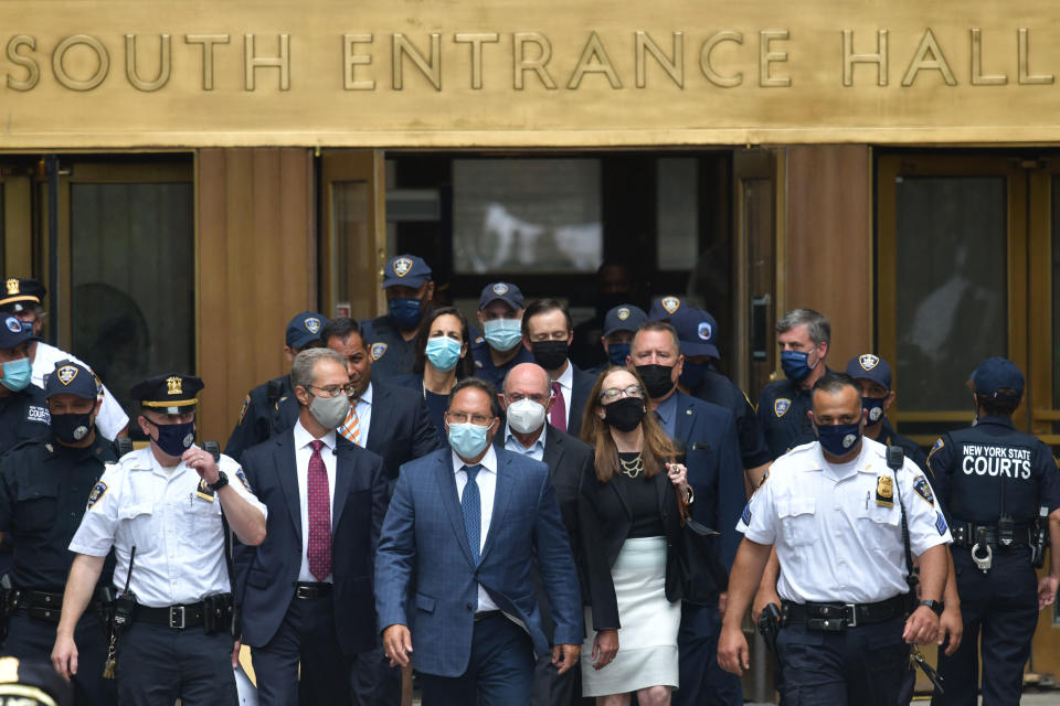 Allen Weisselberg  (C) former US President Donald Trumps company chief financial officer departs the criminal court in lower Manhattan after pleading not guilty to the charges in New York on July 1, 2021. - The long-serving chief financial officer of former president Donald Trump's company pleaded not guilty in a New York court to tax crimes on July 1, 2021. Allen Weisselberg, 73, was brought into the courtroom in handcuffs shortly before 2:15 pm (1815 GMT) for his indictment before a state judge. (Photo by Ed JONES / AFP) (Photo by ED JONES/AFP via Getty Images)