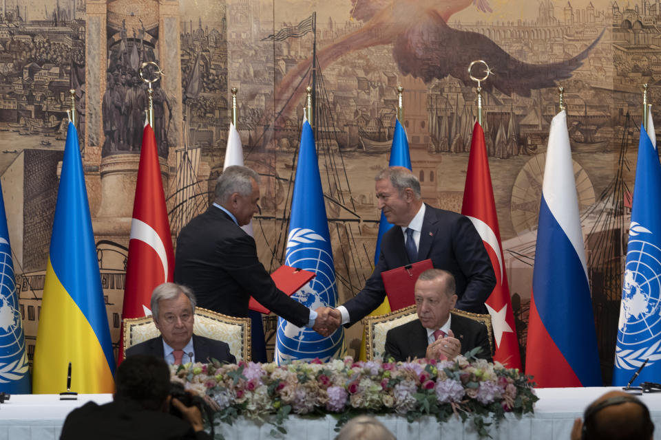 IDENTIFIES TWO PEOPLE SHAKING HANDS - Turkish President Recep Tayyip Erdogan, right, and U.N. Secretary General, Antonio Guterres, sit as Sergei Shoigu, Russia's Defense Minister, and Hulusi Akar, Turkey's Defense Minister. shake hands during a signing ceremony at Dolmabahce Palace in Istanbul, Turkey, Friday, July 22, 2022. U.N. Secretary General Antonio Guterres and Turkish President Recep Tayyip Erdogan were due on Friday to oversee the signing of a key agreement that would allow Ukraine to resume its shipment of grain from the Black Sea to world markets and for Russia to export grain and fertilizers, ending a standoff that has threatened world food security. (AP Photo/Khalil Hamra)