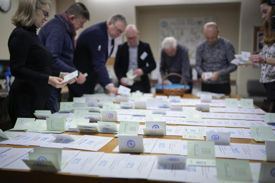 Electoral commission staff count ballot papers after voting closed at a polling station in Tallinn, Estonia, Sunday, March 5, 2023. Voters in Estonia cast ballots Sunday in a parliamentary election that the center-right Reform Party of Prime Minister Kaja Kallas, one of Europe's most outspoken supporters of Ukraine, was considered a favorite to win. (AP Photo/Sergei Grits)