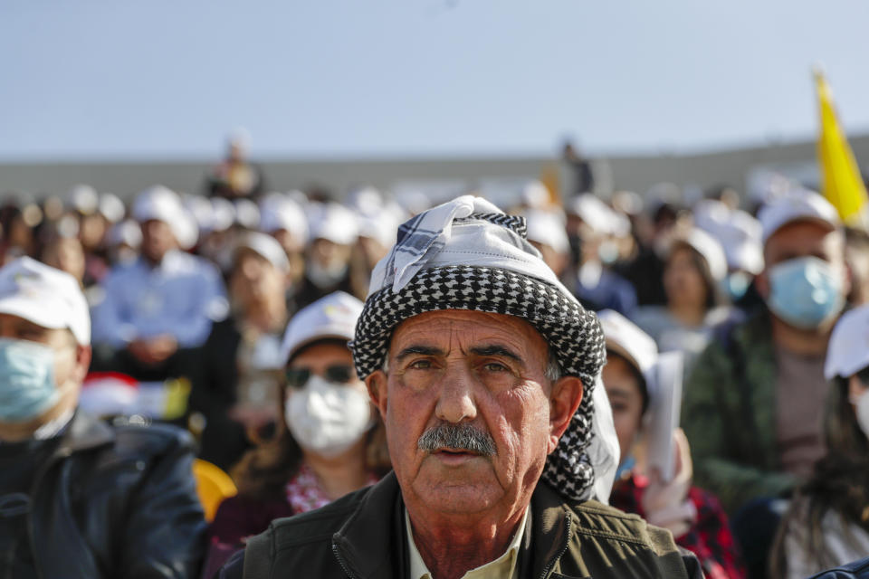 People wait for Pope Francis to celebrate mass at the Franso Hariri Stadium in Irbil, Kurdistan Region of Iraq, Sunday, March 7, 2021. The Vatican and the pope have frequently insisted on the need to preserve Iraq's ancient Christian communities and create the security, economic and social conditions for those who have left to return.(AP Photo/Andrew Medichini)