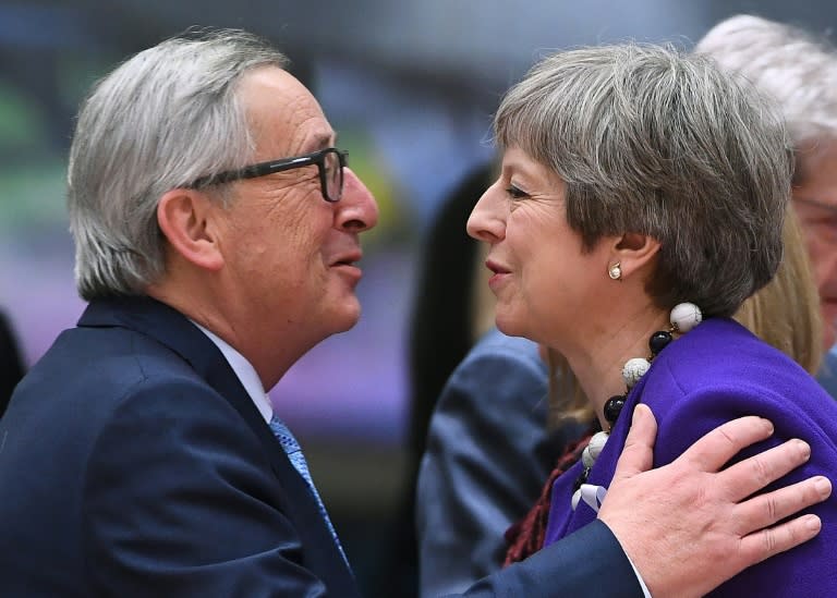 Kiss and break up: EU president Jean-Claude Juncker greets Theresa May at a European summit