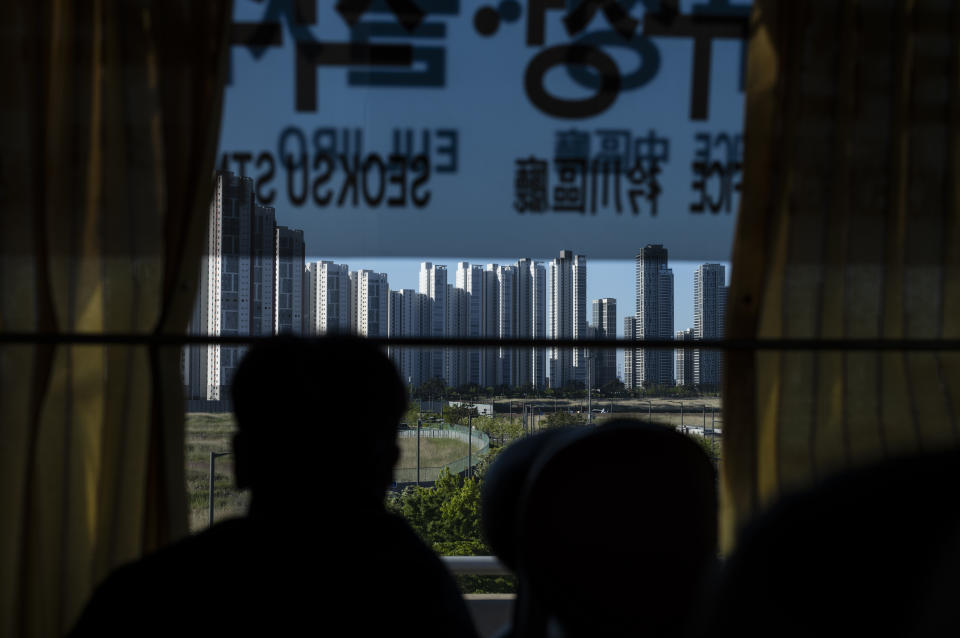 A tourist views high-rise apartment buildings from a bus in Incheon, South Korea, Thursday, May 16, 2024. (AP Photo/Jae C. Hong)