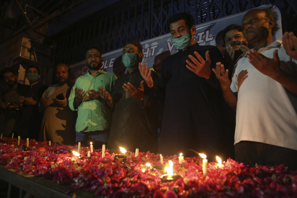 People attend candlelight vigil for victims of the crash of a state-run Pakistan International Airlines plane on Friday, in Karachi, Pakistan, Wednesday , May 27, 2020. (AP Photo/Fareed Khan)