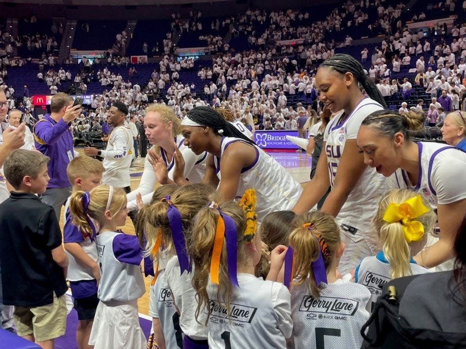 LSU women's basketball team meets with young fans during a recent game this season.