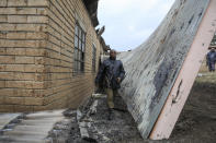 Security forces patrol inside the Lhubiriha Secondary School following an attack on the school on Saturday, in Mpondwe, Uganda Sunday, June 18, 2023, near the border with Congo. Ugandan authorities have recovered the bodies of 41 people including 38 students who were burned, shot or hacked to death after suspected rebels attacked the school, according to the local mayor. (AP Photo/Hajarah Nalwadda)