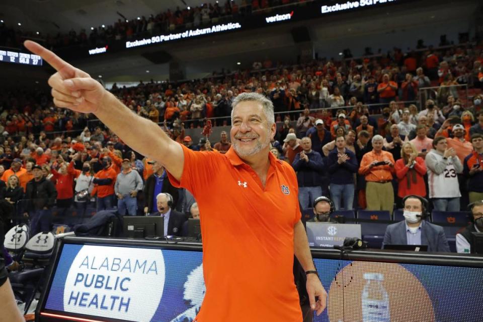 Auburn head coach Bruce Pearl points to the student section after the Tigers beat Kentucky at Auburn Arena during the 2021-22 season. UK went 5-4 on the road in the SEC that season, finishing with a 9-0 league record at home.