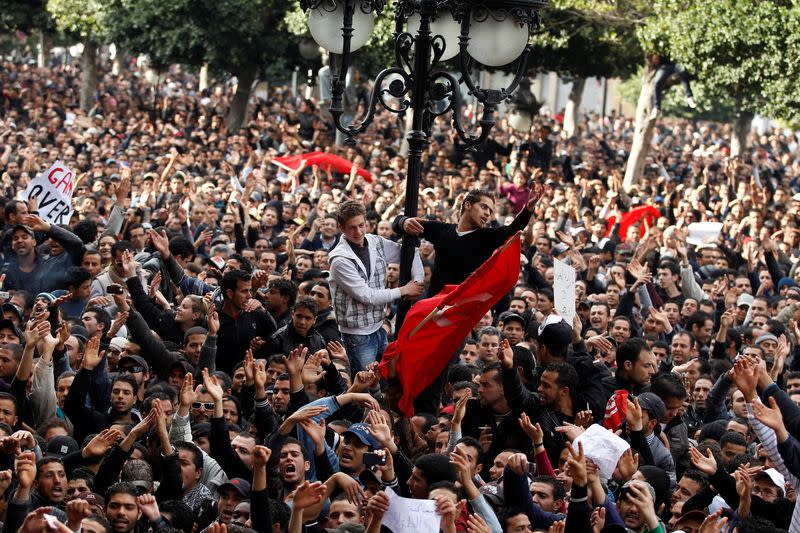 FILE PHOTO: Protesters demonstrate against Tunisian President Zine el-Abidine Ben Ali in Tunis