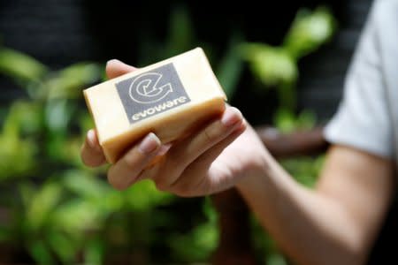 David Christian, co-founder of Evoware, holds a soap after it was wrapped with seaweed-based edible packaging during an interview at his home in Jakarta, Indonesia, October 26, 2017. Picture taken October 26, 2017. REUTERS/Beawiharta