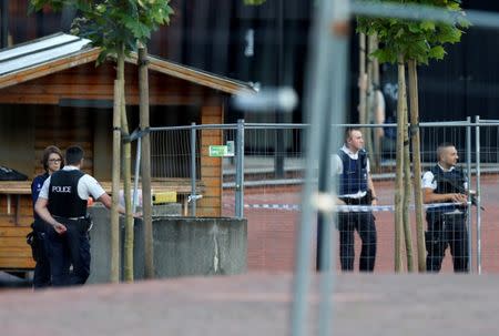 Belgian police officers stand guard outside the main police station after a machete-wielding man injured two female police officers before being shot in Charleroi, Belgium, August 6, 2016. REUTERS/Francois Lenoir